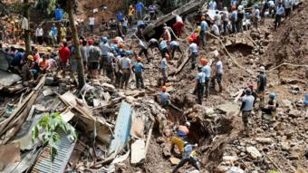 Rescuers search for people trapped in a landslide, after super typhoon Mangkhut hit the country, at a mining camp in Itogon, Benguet, Philippines September 17, 2018