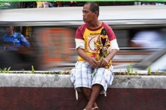 A man holds a replica of the Black Nazarene in Manila (7 Jan 2019)