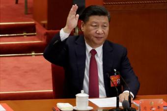 Chinese President Xi Jinping raised his hand as he voted at the closing session of the 19th National Congress of the Communist Party of China at the Great Hall of the People, in Beijing, China 24 October 2017.