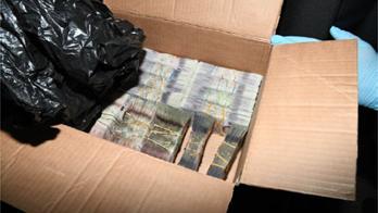 Money in a cardboard box and rubber bands seized by the NCA