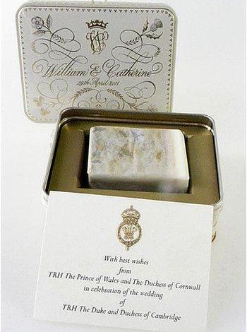 Slice of royal wedding cake in its presentation tin with a note from Prince Charles and the Duchess of Cornwall
