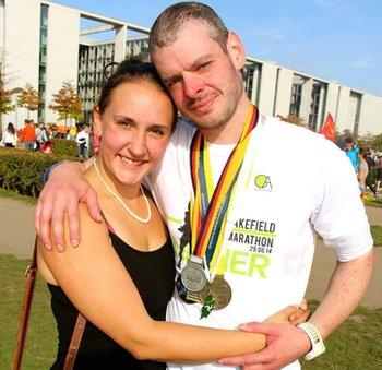 Ben Ashworth with wife Louise and his six medals