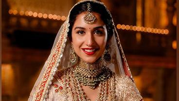 Radhika Merchant smiles in a photoshoot before the wedding