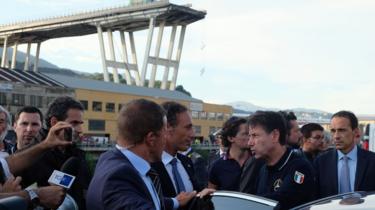 Italian Prime Minister Giuseppe Conte (2ndR) visits the site after a section of the Morandi motorway bridge collapsed in Genoa on August 14, 2018