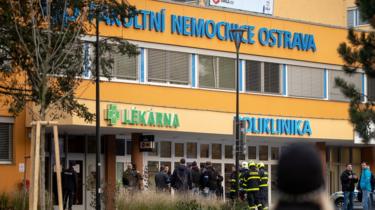 Police officers stand guard near the site of a shooting in front of a hospital in Ostrava, Czech Republic