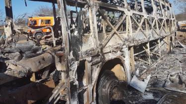 The burnt-out remains of a passenger bus that caught fire are seen near Beitbridge, Zimbabwe