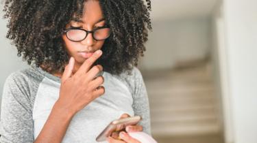 Teenage girl using a smartphone at home