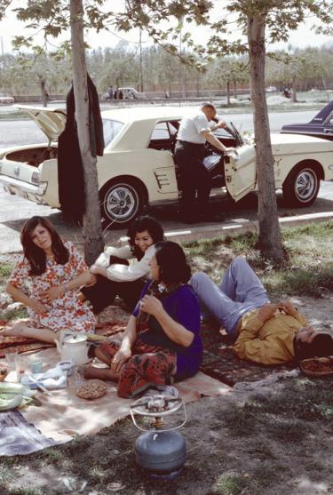 Een groep mannen en vrouwen zit te picknicken in Teheran in 1976. picknick in Teheran in 1976