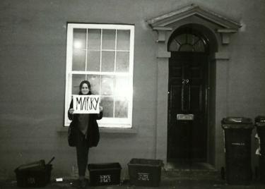 Molly with a sign reading marry