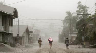 Residents living near the errupting Taal Volcano evacuate in Agoncillo, Batangas City
