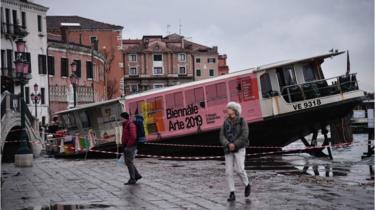 A taxi boat is stranded on the streets of Venice