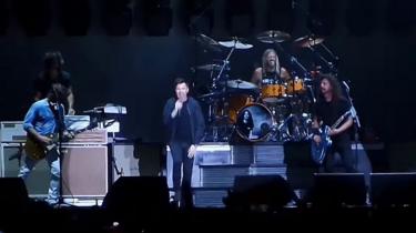Rick Astley on stage with Foo Fighters