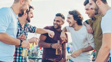 A group of young men, drinking beer and chatting