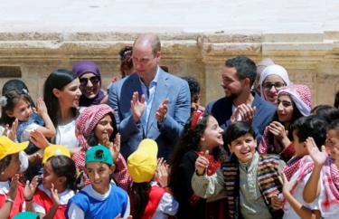 Prince William and Jordan's Crown Prince Hussein interact with children at the ancient city of Jerash