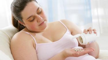 Woman measuring out pills