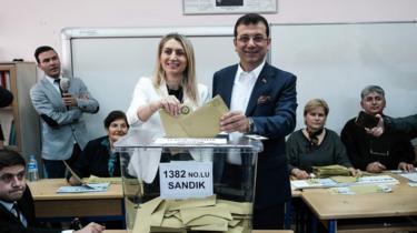 Turkish main opposition party CHP's Istanbul mayoral candidate Ekrem Imamoglu and his wife pose as they cast their votes at a polling station in Istanbul