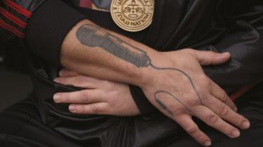 Close up showing tattoo of microphone on Steve's lower arm