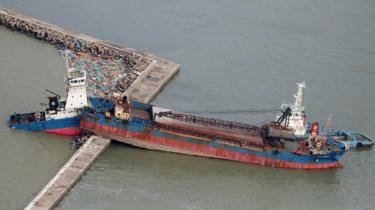 An aerial view from a Jiji Press helicopter shows a ship wedged on a breakwater in Hyogo prefecture