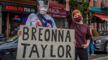 Los manifestantes sostienen una pancarta con el nombre de Breonna Taylor's name