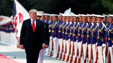 U.S. President Donald Trump reviews an honour guard during a welcome ceremony at the Imperial Palace in Tokyo