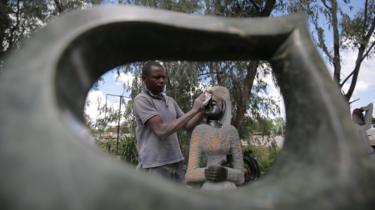 A stone sculptor at work along the highway to the Robert Mugabe International airport, Harare, Zimbabwe, 12 December 2017.