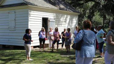 Olivia leading a tour in front of what used be the kitchens where orlaved women worked