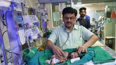 Dr Ravi Khanna with the baby in his hospital