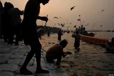 Devotees take a holy dip at Sangam, the confluence of the Ganges, Yamuna and Saraswati rivers, during "Kumbh Mela", or the Pitcher Festival, in Prayagraj, previously known as Allahabad, India, January 14, 201