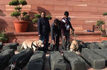 Indian security personnel check bags containing budget documents outside Parliament House in capital Delhi