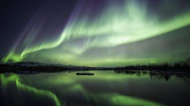 Northern lights blazing over lake Thingvellir national park in Iceland