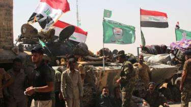 Paramilitary Popular Mobilisation force fighters gather around Tal Afar airport on 27 August 2017