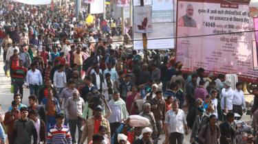 Narendra Modi signboard seen next to crowds