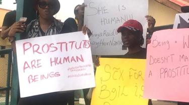 Women carry placards