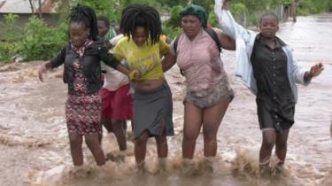 Women wading through water