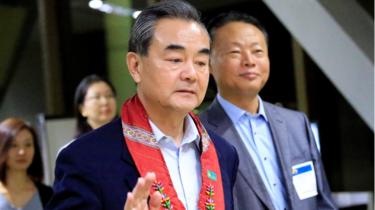 People"s Republic of China Foreign Minister Wang Yi gestures as he is escorted by Zhao Jianhua, Chinese ambassador to the Philippines, upon arrival at the international airport of Pasay to attend the 50th ASEAN Foreign Ministers meeting, metro Manila, Philippines August 5, 2017