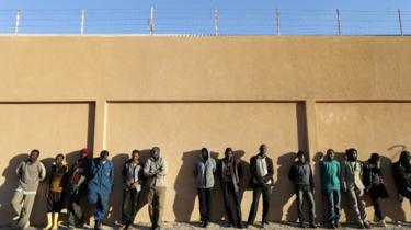 Migrants stand in a detention centre run by the interior ministry of Libya"s eastern-based government, in Benghazi, Libya, December 13, 2017.