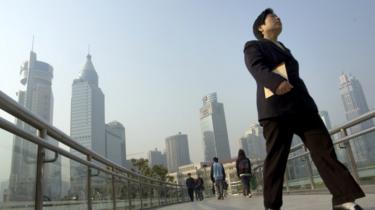 woman in suit walking across bridge