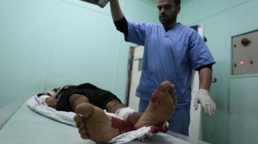 Doctor treats a wounded man at hospital in Rafah on 17 February