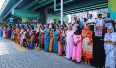 Women stand in a line to take part in a 'women's wall' protest in Kochi in Kerala on 1 January 2019.