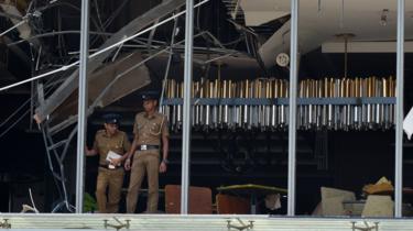 Sri Lankan police at the site of an explosion at the luxury Shangri-La hotel in Colombo.