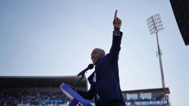 Mmusi Maimane gestures as he delivers a speech on stage to supporters at the Dobsonville Stadium in Soweto, Johannesburg, on May 4, 2019