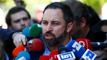 Spain's far-right party Vox candidate Santiago Abascal talks to the media after casting his vote
