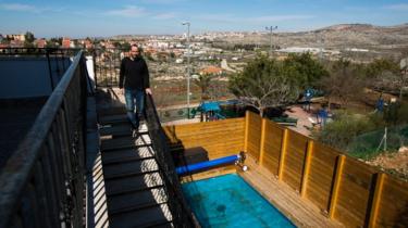 Yoav Sorek is seen as he walks down a staircase at his bed and breakfast 'Nof Ofra' in Israeli settlement in occupied West Bank on 28 January 2016