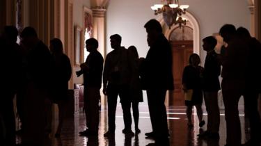 Reporters wait for the arrival of senators for vote on the tax bill on Capitol Hill in Washington, DC on December 1, 2017