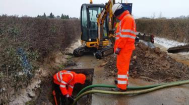 Thames Water staff fixing a pipe