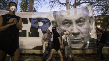 Immagine di Benjamin Netanyahu su uno striscione durante una manifestazione contro la corruzione a Tel Aviv (19/04/20)