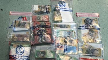 Clear plastic bags filled with Australian currency, alleged to be the proceeds of crime