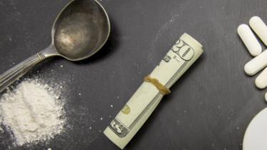 Drugs paraphernalia and US currency