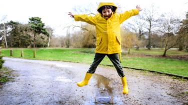 Boy-jumping-in-puddle