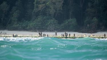 The Sentinelese stand guard on an island beach in 2005